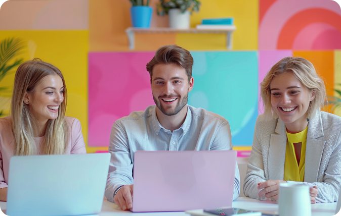 Happy employees working on a laptop.